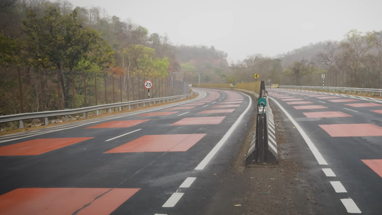 This 'Red Road' Is Designed To Slow Down Drivers And Protect Wild Life - 'red road'
